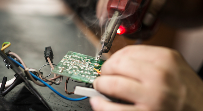 Practicing through-hole soldering on a scrap PCB for skill-building