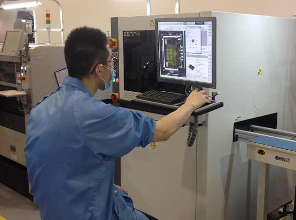 Technician programming an AOI system for PCB inspection